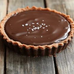 - 1 ½ cups all-purpose flour - ½ cup unsweetened cocoa powder - ½ cup powdered sugar - ½ cup unsalted butter, softened - 1 large egg - 1 cup heavy cream - 8 oz bittersweet dark chocolate, chopped - ½ teaspoon sea salt - 1 tablespoon vanilla extract - Flaked sea salt for garnish The first key ingredient is all-purpose flour. It forms the base of the tart crust. This flour gives the tart its structure. The cocoa powder adds a rich chocolate flavor, making the crust taste amazing. Powdered sugar sweetens the crust and helps it stay tender. Unsalted butter brings richness and moisture to the crust. It also helps bind the ingredients together. Next, we have the egg. This ingredient acts as a binder for the crust. It helps the dough hold together when baked. The heavy cream makes our ganache smooth and creamy. Bittersweet dark chocolate is the star of the tart. It gives a deep, rich chocolate flavor. The sea salt enhances the chocolate taste and balances the sweetness. Finally, vanilla extract adds warmth and depth to the ganache. You can switch up the flavor with a few optional ingredients. For a fruity twist, add a layer of fresh berries on top. You might also try using milk chocolate for a sweeter taste. If you prefer a nutty flavor, add ground nuts to the crust. You could use almond or hazelnut flour instead of some all-purpose flour. Each of these options makes the tart unique and delicious! Start by mixing the dry ingredients in a bowl. Combine 1 ½ cups of flour, ½ cup of cocoa powder, and ½ cup of powdered sugar. This mix gives your crust a rich, chocolate flavor. Next, add ½ cup of softened butter and blend until it looks crumbly. Then, crack in one large egg and mix until the dough holds together. Wrap the dough in plastic wrap. Chill it in the fridge for 30 minutes. This step helps the crust stay crisp. Preheat your oven to 350°F (175°C). After chilling, roll out the dough on a floured surface. Aim for a size that fits a 9-inch tart pan. Press the dough into the pan, making sure to cover the edges. Prick the bottom with a fork to prevent bubbling. Place the tart shell in the oven and bake for 15-20 minutes. Once baked, let it cool completely on a wire rack. This cooling step is key for a good tart. In a small saucepan, pour 1 cup of heavy cream. Heat it over medium heat until it simmers gently. Remove the pan from heat. Now, add 8 oz of chopped bittersweet dark chocolate. Stir in 1 tablespoon of vanilla extract and ½ teaspoon of sea salt. Mix until it becomes smooth and shiny. This ganache will be the star of your tart. Carefully pour the ganache into the cooled tart shell. Use a spatula to smooth the top if needed. Now, cover the tart with plastic wrap and place it in the fridge. Chill for at least 2 hours. This time allows the ganache to set well. When ready to serve, sprinkle flaked sea salt on top for a burst of flavor. Slice and enjoy this delightful treat! To make a great tart crust, use cold butter. This keeps the crust flaky. Make sure to mix the dry ingredients well before adding the butter. This helps the flavors blend. When you roll out the dough, do it on a floured surface. This keeps it from sticking. If the dough cracks, press it back together gently. Chill the dough for a good half hour. This helps it hold its shape when baked. For a smooth ganache, heat the cream until just simmering. Don’t boil it. This can make the chocolate seize up. Use high-quality dark chocolate for the best flavor. Chop it into small pieces for faster melting. Stir the ganache gently until all the chocolate melts. Add the vanilla extract and sea salt after removing it from heat. This keeps the flavors bright and fresh. One mistake is not chilling the crust long enough. This can lead to a soggy base. Another is overcooking the ganache. Keep an eye on the cream as it heats. If you skip the flaked sea salt on top, you miss out on the flavor boost. Lastly, be careful when filling the tart shell. Avoid overfilling to prevent spills. {{image_2}} You can swap out regular sugar for different sweeteners. Try using maple syrup or honey. These add a hint of flavor and can make the tart even more special. Keep in mind that these sweeteners may change the tart's texture, so adjust the liquid in your ganache. For a sugar-free option, look for stevia or monk fruit. Just use them in the same amount as sugar, but check the labels for details. While cocoa powder gives a great taste, you can use different flours. Almond flour or gluten-free flour works well. If you prefer a nutty flavor, add ground nuts to your crust. You can also try a cookie crust made from crushed Oreos or graham crackers. Just mix them with melted butter and press into the pan. Each crust brings its own fun twist to the tart. Enhance your tart with fun flavors. You can add espresso powder to the chocolate ganache for a coffee kick. A splash of orange zest or peppermint extract can brighten the taste. For toppings, try fresh berries, chopped nuts, or caramel drizzle. Flaked sea salt is a must for that sweet and salty combo. Get creative and make it your own! To keep your salted dark chocolate tart fresh, wrap it well. Use plastic wrap or foil. You can also place it in an airtight container. Store it in the fridge. This helps maintain its rich flavor and texture. When stored properly, the tart lasts about 4 to 5 days in the fridge. After that, the taste may change. If you notice any off smells, it's best to throw it away. Always check before serving. You can freeze the tart if you want to save it for later. First, let it cool completely. Wrap it tightly in plastic wrap, and then in foil. It can last up to 2 months in the freezer. To serve, just thaw it in the fridge overnight. Enjoy it chilled or at room temperature. Yes, you can make the tart ahead of time. Prepare the tart and chill it in the fridge. The tart stays fresh for up to three days. This can help save time on busy days or special events. If you need a substitute for bittersweet chocolate, use semi-sweet chocolate. You can also mix dark chocolate with a bit of sugar. This will give you a similar taste and texture. To get the ganache to set, let it cool at room temperature first. Then chill it in the fridge for at least two hours. Make sure the tart shell is cool before adding the ganache. This helps it set better. Yes, you can use dairy-free options! Substitute heavy cream with coconut cream or almond milk. Make sure your chocolate is dairy-free too. This way, you can enjoy the tart without dairy. You learned about making a delicious salted dark chocolate tart. We covered key ingredients, step-by-step instructions, and helpful tips. Variations allow you to customize it to your taste. Proper storage ensures it stays fresh for longer. Now, it’s time to enjoy your tart and impress others with your skills. Happy baking!