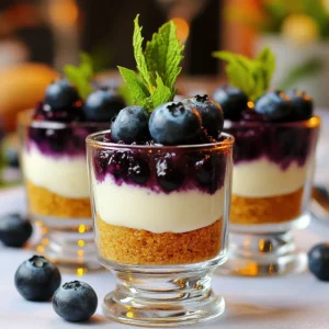 - 1 cup graham cracker crumbs - 4 tablespoons unsalted butter, melted - 2 cups cream cheese, softened - 1 cup powdered sugar - 1 teaspoon vanilla extract - 1 cup heavy cream, whipped - 1 ½ cups fresh blueberries - 2 tablespoons lemon juice - 1 tablespoon cornstarch - Fresh mint leaves for garnish (optional) For these no-bake blueberry cheesecake cups, you need simple items. First, graham cracker crumbs make a crunchy base. Next, melted butter helps bind the crumbs together. The cream cheese gives the filling its rich texture. Powdered sugar adds sweetness, while vanilla extract brings great flavor. Whipped heavy cream makes the filling light and fluffy. Fresh blueberries are key for a fruity topping. Lemon juice brightens the flavor, and cornstarch helps thicken the blueberry mix. You can add mint leaves as a lovely touch on top. Each ingredient plays an important role in making this dessert delicious and fun to eat. Start by mixing your graham cracker crumbs with melted butter in a bowl. Make sure the crumbs look moist and coated. This helps the crust hold together. Next, grab your serving cups or glasses. Press the crumb mixture firmly into the bottom of each cup. Make it even and compact for a good base. Set these cups aside as you move to the next step. In a large mixing bowl, beat the softened cream cheese until it feels smooth. You want a creamy texture with no lumps. Gradually add the powdered sugar and vanilla extract. Mix until everything is well combined. This mixture should be thick but creamy. Gently fold in the whipped heavy cream. This helps make your filling light and fluffy. Take a small saucepan and combine the fresh blueberries, lemon juice, and cornstarch. Cook this mixture over medium heat. Stir it gently until the blueberries start to burst. This should take about 5 to 7 minutes. Once thickened, remove it from heat and let it cool slightly. Cooling is key before adding it to your cups. Now, it’s time to layer the cheesecake cups. Spoon the cream cheese mixture over the crust in each cup. Fill them about two-thirds full to leave room for the blueberries. Next, top each cheesecake cup with a generous spoonful of the cooled blueberry mixture. This creates a beautiful and colorful layer on top. Refrigerate the assembled cups for at least 2 hours. This chilling time helps the filling set properly. Before serving, garnish each cup with fresh mint leaves and a few whole blueberries. This adds a nice touch and makes your dessert look stunning. Enjoy your no-bake blueberry cheesecake cups! - Make sure your cream cheese is at room temperature. This helps it blend smoothly. - To achieve fluffy whipped cream, beat the heavy cream until soft peaks form. Stop mixing once you see the peaks. - Avoid overmixing the filling. This can make it dense and less creamy. - Let the blueberries cool properly after cooking. This prevents melting the cream layer. - Add citrus zest, like lemon or lime, to brighten the filling. - Try other fruit toppings, such as strawberries or raspberries, for a twist. {{image_2}} You can switch things up by using different fruits. Strawberries or raspberries make great alternatives to blueberries. Their bright colors and flavors add a fresh twist. If you prefer something richer, try a chocolate ganache. Just melt dark chocolate and mix it with cream for a creamy topping. For a gluten-free option, use gluten-free graham crackers or nuts for the crust. You can also make this cheesecake vegan. Substitute cream cheese with cashew cream or tofu blended until smooth. Use maple syrup instead of powdered sugar for sweetness. Adding extracts can elevate your cheesecake. A splash of almond or lemon extract can enhance the taste. You can also sprinkle in spices like cinnamon or nutmeg for warmth. These little adjustments can make your cheesecake unique and exciting. To keep your no-bake blueberry cheesecake cups fresh, store them in the refrigerator. Use an airtight container or cover each cup with plastic wrap. This keeps them safe from odors and moisture. They will taste best when served cold. If you have leftovers, you can freeze them. Just make sure to wrap each cup tightly in plastic wrap and then place them in a freezer-safe bag. They can last in the freezer for about one month. These cheesecake cups stay fresh in the fridge for about three days. If you freeze them, they maintain good quality for about one month. Watch for signs of spoilage. If you see any off smells, mold, or a change in texture, it’s best to throw them out. Keeping an eye on your treats ensures every bite is a delight. Enjoy your creamy dessert safely! Yes, you can make these cheesecake cups a day in advance. Just store them in the fridge. This lets the flavors blend well, making them even tastier. These cheesecake cups need at least 2 hours to set in the fridge. If you can wait longer, they will taste even better. The longer chill time helps the layers firm up nicely. Yes, you can use a store-bought crust. It saves time and still tastes great. Just make sure it fits your serving cups well. You can use whipped coconut cream or almond milk. These options work well but may change the texture a bit. If you use coconut cream, it can add a nice flavor twist. Yes, frozen blueberries work just fine. Just be sure to thaw and drain them first. This helps avoid extra moisture in your cheesecake cups. These cheesecake cups are easy and fun to make. You learned how to prepare the crust, make the filling, and create a tasty blueberry topping. I highlighted tips to avoid mistakes and ways to customize flavors. Involving fresh ingredients brings joy to your dessert. Whether you follow recipes or experiment, enjoy every bite. Happy baking and savoring your creations!