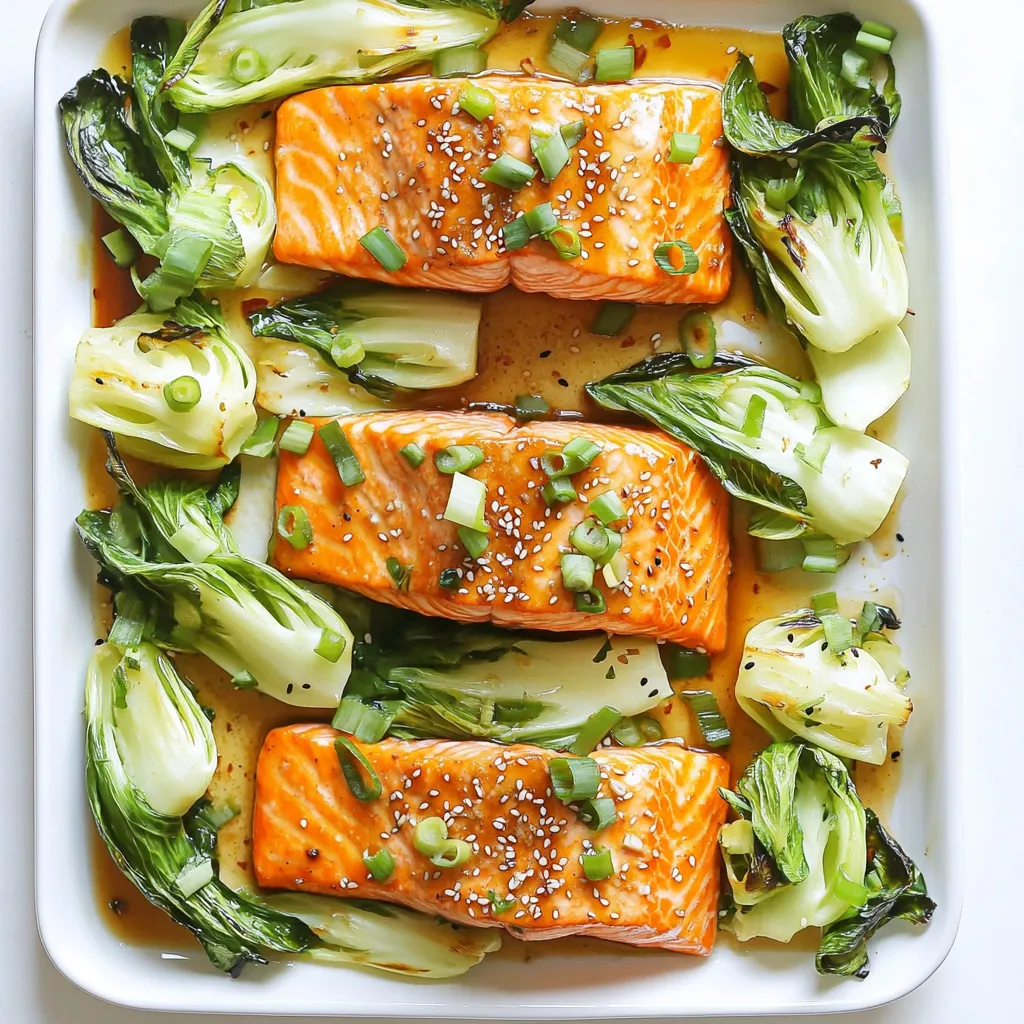 - 4 salmon fillets (6 oz each) - 2 cups bok choy, chopped - 3 tablespoons soy sauce (or tamari for gluten-free) - 2 tablespoons sesame oil - 1 tablespoon fresh ginger, minced - 1 tablespoon honey - 1 teaspoon garlic, minced - Salt and pepper to taste - 2 tablespoons sesame seeds, toasted - Green onions, chopped for garnish The main ingredients focus on fresh flavors. Salmon gives a rich taste, while bok choy adds crunch. The marinade combines soy sauce, sesame oil, ginger, honey, and garlic. This mix makes each bite burst with flavor. - Tamari for gluten-free - Extra sesame seeds and green onions for garnish Using tamari instead of soy sauce keeps the dish gluten-free. Adding more sesame seeds and green onions enhances both taste and look. These optional items bring more texture and freshness to your meal. - Baking sheet - Parchment paper - Mixing bowls You need a baking sheet for roasting. Parchment paper helps with easy cleanup. Mixing bowls are great for whisking the marinade. Having these tools ready makes cooking smoother. Each ingredient plays a vital role in this dish. The right tools make the process easier and more enjoyable. 1. Preheat your oven to 400°F (200°C). This high heat helps cook the salmon and bok choy quickly. 2. Line a large baking sheet with parchment paper. This step makes cleanup a breeze. 3. In a small bowl, whisk together the soy sauce, sesame oil, minced ginger, honey, garlic, salt, and pepper. This marinade adds great flavor to the salmon. 1. Place the salmon fillets on one side of the prepared baking sheet. Each fillet should have space to cook evenly. 2. Brush the marinade over the salmon. Make sure to coat each piece well to enhance the flavor. 3. In a separate bowl, toss the chopped bok choy with a drizzle of olive oil, salt, and pepper. This adds flavor and helps it crisp up. 4. Arrange the bok choy on the other side of the baking sheet. 1. Bake the salmon and bok choy in the preheated oven. Set your timer for 15-20 minutes. 2. Check for doneness by using a fork. The salmon should flake easily. The bok choy should be tender with crispy edges. 3. Once done, take it out and sprinkle toasted sesame seeds over the salmon and bok choy. 4. For a finishing touch, garnish with chopped green onions before serving. - Best practices for salmon doneness: Salmon is done when it flakes easily with a fork. At 400°F, cook for 15-20 minutes. Use a meat thermometer; aim for 145°F in the thickest part. This gives you moist, tender fish. If you prefer a crispy top, broil it for the last 2 minutes. - How to achieve crispy bok choy: For crispy bok choy, space it well on the pan. Avoid overcrowding. Toss it lightly with olive oil, salt, and pepper. Bake until the edges are golden brown. This keeps the texture crunchy and fresh. - Additional marinade variations: You can spice it up! Try adding sriracha for heat or orange juice for a citrus twist. A splash of rice vinegar adds brightness too. Mix and match for your favorite flavor. - Recommended sides to complement the dish: Serve this dish with jasmine rice or quinoa for a hearty meal. Steamed edamame or a simple cucumber salad can add freshness. These sides balance the rich salmon and bok choy flavors. - Plating ideas and garnishing tips: For a stunning plate, use a large white platter. Arrange salmon and bok choy in a colorful way. Drizzle any leftover marinade over the top. Finish with extra sesame seeds and chopped green onions for a pop of color. {{image_2}} You can easily change the fish in this recipe. Trout or tilapia works great instead of salmon. Each fish brings its own flavor and texture. If you want a vegan or vegetarian option, try marinated tofu or tempeh. Both soak up the flavors well and add protein. If you want to avoid soy sauce, use coconut aminos. It has a similar taste but is lighter. You can also try using herbs like cilantro or basil. Fresh herbs add bright notes to the dish. Spices like chili flakes or cumin can give it a different twist. Just remember to adjust based on your taste. Grilling is a fun option if you want a smoky flavor. You can grill the salmon and bok choy on a barbecue instead of using the oven. If you prefer a mix of veggies, try bell peppers or asparagus on the sheet pan. They also roast well and add color to your meal. To store leftovers properly, let the salmon and bok choy cool down first. Place them in an airtight container. This helps to keep them fresh. You can keep them in the fridge for up to three days. Make sure to label the container with the date. For freezing, wrap each salmon fillet in plastic wrap. Place them in a freezer bag, removing as much air as possible. Bok choy can also be frozen. Chop it and place it in a freezer bag. For best results, use within three months. When thawing, move the salmon and bok choy to the fridge overnight. This method helps keep their texture nice. You can also use a microwave for quick thawing, but be careful not to cook them. Reheat the salmon and bok choy in the oven for the best results. Preheat your oven to 350°F (175°C). Place them on a baking sheet for about 10 minutes. This keeps them moist and tasty. You can also use a microwave. Heat in short bursts of 30 seconds until warm. Remember to cover them with a damp paper towel to keep moisture in. It takes about 15 to 20 minutes to cook salmon at 400°F. For thick fillets, aim for the longer time. For thin fillets, check for doneness at around 15 minutes. Salmon is done when it flakes easily with a fork. Remember, you want it moist but fully cooked. Yes, you can use frozen salmon. Just thaw it before cooking. If the salmon is still a bit frozen in the middle, add a few extra minutes to the cooking time. Be sure to check that it's cooked through. The same marinade works well, and it adds great flavor. You can serve this dish with rice or quinoa for a full meal. Steamed jasmine rice pairs well and soaks up the sauce. You might also add a simple cucumber salad for freshness. Try to keep the sides light to balance the rich flavors of the salmon. This blog post detailed how to make a delicious sheet-pan sesame ginger salmon. We covered ingredients, preparation steps, cooking tips, and variations to suit your taste. Remember, you can swap ingredients and adjust cooking methods to fit your needs. With a few simple techniques, you can create a meal that's both easy and flavorful. Enjoy cooking, and don’t hesitate to experiment!