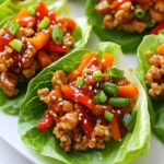To make sweet chili chicken lettuce cups, you need the following: - 1 lb (450g) ground chicken - 1 tablespoon sesame oil - 2 garlic cloves, minced - 1 inch piece of ginger, grated - 3 tablespoons sweet chili sauce - 2 tablespoons soy sauce - 1 tablespoon rice vinegar - 1 cup red bell pepper, finely diced - 1 cup carrots, shredded - ½ cup green onions, sliced - 1 head of butter lettuce or iceberg lettuce, leaves separated - 1 tablespoon sesame seeds (for garnish) These tools can make your cooking easier: - A large skillet for cooking - A spatula for stirring - A grater for ginger - A knife and cutting board for veggies - Measuring spoons for accuracy You can swap ingredients to fit your taste: - Use turkey instead of chicken for a lean option. - Swap sesame oil for olive oil if needed. - Try lime juice instead of rice vinegar for a different taste. - Use any color bell pepper you like. - For crunch, add chopped nuts like peanuts or cashews. {{ingredient_image_1}} 1. First, heat 1 tablespoon of sesame oil in a large skillet over medium heat. 2. Next, add 2 minced garlic cloves and 1 inch of grated ginger. Sauté for 1 minute. 3. Now, add 1 pound of ground chicken to the skillet. Cook for 5-7 minutes. Break it apart with a spatula until it’s browned and cooked through. 4. Stir in 3 tablespoons of sweet chili sauce, 2 tablespoons of soy sauce, and 1 tablespoon of rice vinegar. Mix well. 5. Add 1 cup of finely diced red bell pepper and 1 cup of shredded carrots. Cook for 2-3 minutes until the veggies are tender. 6. Remove the skillet from heat and stir in ½ cup of sliced green onions. 7. To serve, spoon the chicken mixture into the center of each lettuce leaf. Fold it like a taco. 8. Finally, sprinkle with 1 tablespoon of sesame seeds for crunch and garnish. - Use fresh garlic and ginger for a stronger taste. - Adjust sweet chili sauce based on your spice preference. - Let the mixture cool a bit before serving to enhance flavors. - Arrange the filled lettuce cups on a nice platter. - Drizzle some extra sweet chili sauce over the top. - Add more sesame seeds for a pretty finish. One mistake many make is overcooking the chicken. Cook it just until it turns brown. This keeps it juicy. Another mistake is not prepping your veggies first. Prepare the bell pepper and carrots ahead of time. This makes cooking go smoothly. To boost flavors, use fresh garlic and ginger. Their taste stands out more than dried spices. You can also try adding lime juice for a zesty twist. A splash of lime brightens every bite. For added crunch, include chopped nuts like peanuts. Start by heating the skillet well before adding oil. This helps the chicken brown evenly. Use a spatula to break up the meat as it cooks. Make sure you mix in the sauces well. This ensures every bite is packed with flavor. Pro Tips Use Fresh Ingredients: Fresh vegetables and herbs will enhance the flavor and crunch of your lettuce cups, making them more enjoyable. Adjust Spice Levels: If you prefer more heat, add some chopped fresh chilies or a dash of sriracha to the chicken mixture. Make Ahead: Prepare the chicken filling in advance and store it in the refrigerator for up to 2 days. Just reheat before serving! Experiment with Fillings: Feel free to mix in other vegetables like zucchini or mushrooms for added texture and flavor variety. {{image_2}} You can easily make Sweet Chili Chicken Lettuce Cups vegetarian. Use 1 pound of diced firm tofu instead of ground chicken. Tofu absorbs flavors well, so marinate it in sweet chili sauce and soy sauce for extra taste. Cook it just like you would the chicken. You can also add chopped mushrooms for a meaty texture. To make these lettuce cups gluten-free, use tamari instead of soy sauce. Tamari is a gluten-free soy sauce that gives the same taste. Always check the label on your sweet chili sauce to ensure it is gluten-free. This small change keeps the dish tasty and safe for gluten-free diets. If you like spice, feel free to amp it up! Add chopped fresh chili peppers when you cook the garlic and ginger. You can also sprinkle in some red pepper flakes with the chicken. For a different kick, drizzle some sriracha over the finished cups. Adjust the heat to fit your taste buds, and enjoy! After you enjoy your Sweet Chili Chicken Lettuce Cups, store leftovers in an airtight container. This keeps them fresh for later. Make sure to separate the chicken mixture from the lettuce leaves. The lettuce wilts quickly, so store it apart to keep it crisp. When it’s time to eat your leftovers, here’s how to reheat them. Use a skillet over medium heat. Add the chicken mixture and stir until it’s hot. This method helps keep the flavors intact. Avoid the microwave if you can, as it can make the chicken dry. Leftovers last in the fridge for up to three days. If you want to store them longer, consider freezing the chicken mixture. It stays good for about three months in the freezer. Just remember to thaw it overnight in the fridge before reheating. Enjoy your tasty meal anytime! I recommend using butter lettuce or iceberg lettuce. These types are soft and sturdy. They hold the filling well without tearing. Butter lettuce has a nice, sweet taste. Iceberg adds a crisp, cool crunch. Both options make great cups for your filling. Yes, you can meal prep these lettuce cups. Cook the chicken mixture ahead of time. Store it in an airtight container in the fridge. You can keep it fresh for up to three days. When ready to eat, simply spoon the mix into the lettuce leaves. This makes for a quick and easy meal. You can easily change the flavors to suit your family’s taste. Try adding more sweet chili sauce for extra sweetness. If you like spice, add some chopped chilies or sriracha. You can also mix in different veggies like cucumbers or corn. Get creative and make it your own! In this article, we explored key ingredients, cooking steps, and helpful tips for making delicious Sweet Chili Chicken Lettuce Cups. You learned about substitutions and how to avoid common mistakes. Remember, you can enhance flavors and try new variations, like gluten-free or spicy options. Proper storage and reheating will keep your meal fresh and tasty. With these insights, you now have the tools to create a wonderful dish for any occasion. Happy cooking!