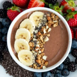 For this Chocolate Peanut Butter Banana Smoothie Bowl, you need: - 2 ripe bananas (one should be frozen) - 2 tablespoons natural peanut butter - 1 cup unsweetened almond milk (or any milk you like) - 2 tablespoons cocoa powder - 1 tablespoon honey or maple syrup (optional) - 1/2 teaspoon vanilla extract These ingredients come together to create a rich, creamy base. The ripe bananas add natural sweetness and creaminess. The frozen banana helps chill the smoothie, making it thick and smooth. Natural peanut butter gives a nutty flavor and healthy fats. Unsweetened almond milk keeps it light. Cocoa powder adds that chocolatey goodness. If you need more sweetness, honey or maple syrup works great. Finally, a touch of vanilla extract enhances the overall flavor. You can make your smoothie bowl even better with these toppings: - Sliced banana - Granola - Chopped nuts - Chia seeds - Cocoa nibs - Fresh berries These toppings add fun textures and flavors. Sliced bananas and berries add freshness. Granola provides a nice crunch. Chopped nuts give a hearty feel. Chia seeds add fiber and a bit of chew. Cocoa nibs offer a rich chocolate hit. Choose your favorites or mix them all for a delightful experience! {{ingredient_image_1}} 1. Start with two ripe bananas. One should be frozen. 2. Place the ripe banana, frozen banana, peanut butter, almond milk, cocoa powder, honey, and vanilla in a blender. 3. Blend on high speed until the mix is smooth and creamy. 4. If it’s too thick, add more almond milk. Blend again until you reach your desired texture. 1. Pour the smoothie into a bowl. 2. Now, it’s time to get creative! Arrange your toppings on top. 3. Start with slices of banana followed by granola, chopped nuts, chia seeds, cocoa nibs, and fresh berries. 4. Enjoy with a spoon right away! Dive into that tasty goodness! To get a smooth and creamy texture, blend well. Start with the ripe banana and the frozen banana. This mix gives your bowl a nice chill. Add the peanut butter, almond milk, cocoa powder, honey, and vanilla extract. Blend on high speed until everything is smooth. If the mix is too thick, add a little more almond milk. Blend again to reach the perfect consistency. For the best flavor, use bananas that are ripe but not overripe. A ripe banana has brown spots. This shows it is sweet and soft. Avoid using bananas that are too green. Green bananas taste starchy and less sweet. You can change the sweetness to fit your taste. If you want it sweeter, add more honey or maple syrup. You can also skip the sweetener entirely if you prefer less sugar. For a protein boost, add a scoop of protein powder. This makes the smoothie more filling. You can also add a handful of greens like spinach. The flavor remains great, and it adds nutrients. Pro Tips Use Frozen Bananas: For a thicker and creamier texture, use one frozen banana in your smoothie. It will also keep your smoothie cold without the need for ice. Adjust Sweetness: Depending on your preference, you can adjust the sweetness of your smoothie by varying the amount of honey or maple syrup, or by adding more ripe bananas. Experiment with Toppings: Feel free to customize your toppings! Add your favorite fruits, seeds, or nut butters to make the smoothie bowl uniquely yours. Blend Thoroughly: To achieve the perfect smoothness, blend your ingredients on high speed for at least 30 seconds, stopping to scrape down the sides as needed. {{image_2}} You can change the taste by using different nut butters. Almond butter or cashew butter works great too. Each nut butter adds its unique flavor. You can mix things up to find your favorite! Using various types of milk also makes a difference. If you want a creamier bowl, try coconut milk. For a lighter option, use oat milk. Each milk brings its own taste and texture. Experiment with what you like! If you're vegan, it's easy to make this smoothie bowl fit your needs. Just skip the honey and use maple syrup instead. This keeps it sweet without any animal products. For gluten-free options, this recipe is already safe! The ingredients have no gluten. Just make sure your toppings are also gluten-free. This way, everyone can enjoy this tasty treat! To keep your leftover smoothie fresh, pour it into an airtight container. Seal the lid tightly. Store it in the fridge for up to 24 hours. When you are ready to enjoy it, give it a good stir. If it seems too thick, add a splash of almond milk to thin it out. If you want to freeze ingredients for later, peel and slice ripe bananas. Place the slices in a single layer on a baking sheet. Freeze them for about two hours. Once frozen, transfer the banana slices to a freezer bag. This way, you can easily grab a few pieces when you make your next smoothie bowl. In the fridge, your leftover smoothie will last about one day. After that, the taste and texture may change. If you freeze your smoothie, it can last up to three months. Just remember to thaw it overnight in the fridge before you enjoy it. This ensures a smooth and creamy experience. Can I make this smoothie bowl without bananas? You can skip the bananas. Try using avocados or silken tofu instead. Both add creaminess without the banana flavor. You may need to adjust the sweetness and flavor with cocoa powder or sweeteners. How can I make it less sweet? To reduce sweetness, cut back on honey or maple syrup. You can also use unsweetened cocoa powder and avoid sweet toppings like granola. Add more almond milk for a lighter taste. What can I substitute for peanut butter? Try almond butter, sunflower seed butter, or cashew butter. These options give a different flavor but still add creaminess. Make sure to choose a natural version for the best taste. This blog explored how to make a delicious smoothie bowl with ripe bananas, peanut butter, and almond milk. We discussed toppings, blending tips, and tasty variations to suit your taste. Storing your smoothie correctly keeps it fresh, and we answered common questions to help you out. Smoothie bowls are simple to customize, fun, and healthy. Enjoy creating your perfect bowl today!