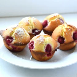 To make Lemon Raspberry Muffins, gather these ingredients: - 1 ½ cups all-purpose flour - 1 cup fresh raspberries (or frozen, thawed and drained) - ½ cup granulated sugar - 2 teaspoons baking powder - ½ teaspoon baking soda - ½ teaspoon salt - 1 large egg - ⅓ cup vegetable oil - ⅓ cup buttermilk (or milk with a splash of lemon juice) - Zest of 1 lemon - 2 tablespoons fresh lemon juice - 1 teaspoon vanilla extract - Optional: powdered sugar for dusting If you can’t find fresh raspberries, you can use frozen ones. Just thaw and drain them. For buttermilk, mix regular milk with a little lemon juice. This will give you a similar tangy flavor. If you don’t have vegetable oil, you can use canola oil or melted coconut oil. Always use the right tools for measuring. For flour, spoon it into your measuring cup, then level it off. This prevents packing too much flour. Use a liquid measuring cup for wet ingredients, like oil or buttermilk. When measuring sugar, scoop it into the cup, then level it. Accurate measuring helps your muffins rise well and taste great. {{ingredient_image_1}} First, preheat your oven to 375°F (190°C). This helps the muffins rise well. Line your muffin tin with paper liners or grease it lightly. This step ensures easy removal later. In a bowl, whisk together 1 ½ cups of all-purpose flour, ½ cup of sugar, 2 teaspoons of baking powder, ½ teaspoon of baking soda, and ½ teaspoon of salt. Mix well until everything is combined. This mix gives the muffins their structure and flavor. In a separate bowl, beat 1 large egg. Add ⅓ cup of vegetable oil, ⅓ cup of buttermilk, the zest of 1 lemon, 2 tablespoons of fresh lemon juice, and 1 teaspoon of vanilla extract. Whisk all these together until smooth and creamy. These ingredients bring moisture and zest to the muffins. Now, take your dry mix and pour in the wet mix. Gently stir with a spatula until just combined. It’s okay to have some lumps! Next, carefully fold in 1 cup of fresh raspberries. This adds a burst of flavor and color to each muffin. Spoon the batter into the muffin cups, filling each about ⅔ full. Bake them in the oven for 18-20 minutes. Check for doneness by inserting a toothpick into the center. If it comes out clean, your muffins are ready! Let them cool in the tin for 5 minutes, then move them to a wire rack. Enjoy your tasty treats! To get soft muffins, mix the dry and wet ingredients gently. Overmixing leads to tough muffins. Aim for a few lumps in the batter. This method keeps your muffins light and fluffy. Remember, the key is not to stir too much. Store your muffins in an airtight container. This keeps them moist and tasty. If you plan to eat them later, place parchment paper between layers. This prevents them from sticking together. For longer storage, freeze the muffins. Wrap each in plastic wrap and place them in a freezer bag. Fresh raspberries give a bright flavor and firm texture. If using frozen raspberries, thaw and drain them first. This avoids excess moisture in the batter. Gently fold them in to maintain their shape. Both options work well, so choose what you prefer! Pro Tips Fresh Raspberries: Using fresh raspberries will give your muffins the best flavor and texture. If using frozen, ensure they are thoroughly thawed and drained to prevent excess moisture. Don’t Overmix: Mix the batter until just combined to keep your muffins light and fluffy. A few lumps are okay; overmixing can lead to dense muffins. Room Temperature Ingredients: Make sure your egg and buttermilk are at room temperature for the best emulsification, leading to a smoother batter and better rise. Cooling Time: Allow the muffins to cool in the pan for a few minutes before transferring to a wire rack. This helps them set and makes them easier to remove without breaking. {{image_2}} You can make these muffins even more fun. Try adding nuts like walnuts or pecans. They add a nice crunch. You can also mix in chocolate chips for a sweet twist. Dark chocolate pairs well with the tart raspberries. Just add about half a cup of your choice when you fold in the raspberries. If you need a gluten-free option, use gluten-free all-purpose flour. Many brands work well in baking. Check that it has a binding agent, like xanthan gum. This will keep your muffins from crumbling. You may need to adjust the liquid slightly. Start with the same amount and then add more if needed. If you don't have fresh lemons, try using lemon extract. Use about a teaspoon for a strong lemon flavor. You can also use bottled lemon juice. It won’t taste as fresh, but it works in a pinch. Just be sure to adjust for sweetness, as bottled juice can be more sour. To keep your Lemon Raspberry Muffins fresh, store them in an airtight container. You can also use a zip-top bag. Place a paper towel inside to absorb extra moisture. This helps keep them fluffy and tasty. Store them at room temperature for up to three days. If you want to keep them longer, freezing is the best option. For long-term storage, freeze your muffins. First, let them cool completely. Then wrap each muffin in plastic wrap. After that, place them in a freezer-safe bag. Be sure to label the bag with the date. These muffins will stay good in the freezer for up to three months. When you're ready to enjoy them, just thaw them at room temperature. To reheat your muffins, use the oven or microwave. For the oven, preheat it to 350°F (175°C). Place the muffins on a baking sheet for about 10 minutes. This keeps the outside crispy. If you use the microwave, heat them for 15-30 seconds. Check them to avoid overheating. Enjoy your muffins warm, and they will taste fresh out of the oven! Yes, you can use frozen raspberries. Just thaw and drain them first. This helps avoid extra moisture in your muffins. They will still taste great! You can make a few small changes. Use whole wheat flour instead of all-purpose flour. You can also reduce the sugar by a bit. Try using honey or maple syrup for a natural sweetener. Replace half of the oil with applesauce for moisture. If you don’t have buttermilk, you can make some at home. Just mix regular milk with a splash of lemon juice or vinegar. Let it sit for about 5 minutes. This will give you a nice, tangy flavor. These muffins stay fresh for about 2 to 3 days at room temperature. Store them in an airtight container. If you want them to last longer, you can freeze them. They will keep well in the freezer for up to 3 months. Absolutely! Just adjust the baking time. Mini muffins usually take about 10 to 15 minutes to bake. Keep an eye on them to avoid overbaking. They will be a fun bite-sized treat! This post covered the key ingredients, precise steps, and tips for perfect Lemon Raspberry Muffins. You learned how to measure accurately, mix ingredients, and achieve a great texture. We also discussed storage and variations to keep your muffins fresh and exciting. Remember, baking is both a science and an art. Use these tips, and enjoy your delicious, homemade muffins! Happy baking!