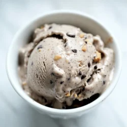 To make this tasty treat, gather these key ingredients: - 2 cups heavy cream - 1 cup whole milk - 3/4 cup granulated sugar - 1 teaspoon vanilla extract - 1/2 teaspoon salt - 1 cup mini chocolate chips - 1/2 cup all-purpose flour - 1/4 cup brown sugar - 2 tablespoons unsalted butter, softened - 1 teaspoon vanilla extract (for cookie dough) - 1 tablespoon milk (for cookie dough) These ingredients create a rich base and yummy cookie dough. The heavy cream and whole milk give our ice cream a creamy texture. The sugars add sweetness, while the chocolate chips bring that classic chocolate chip flavor. You can boost the flavor with a few fun extras: - Add a pinch of cinnamon for warmth. - Mix in chopped nuts for crunch. - Swirl in some fudge or caramel for extra sweetness. These additions can make your ice cream even more special. Feel free to get creative! To make this ice cream, you will need the right tools: - Large mixing bowls - Whisk - Ice cream maker - Airtight container for freezing Having these items ready helps ensure a smooth process. Each tool plays a part in creating your delicious ice cream. {{ingredient_image_1}} To start, gather your ingredients. You will need: - 2 cups heavy cream - 1 cup whole milk - 3/4 cup granulated sugar - 1 teaspoon vanilla extract - 1/2 teaspoon salt In a large bowl, whisk the heavy cream, whole milk, and sugar together. Add the vanilla extract and salt, mixing until smooth. This mixture is your ice cream base. Set it aside while you make the cookie dough. Now, let’s make the cookie dough. You will need: - 1/2 cup all-purpose flour - 1/4 cup brown sugar - 2 tablespoons unsalted butter, softened - 1 teaspoon vanilla extract (for the cookie dough) - 1 tablespoon milk (for the cookie dough) - 1 cup mini chocolate chips In a separate bowl, mix the softened butter and brown sugar until creamy. Add the vanilla extract and milk. Stir until combined. Gradually mix in the flour until a soft dough forms. Finally, fold in the mini chocolate chips. Set this cookie dough aside to cool. Once your ice cream base is chilled, it’s time to churn. Pour the ice cream base into your ice cream maker. Follow the manufacturer’s instructions and churn until it reaches a soft-serve texture. Next, take your cookie dough and break it into small chunks. Once the ice cream is ready, gently fold in these cookie dough pieces. Now, transfer the ice cream to an airtight container. Freeze it for at least 4 hours or until firm. When it's ready, scoop it into bowls or cones and enjoy your homemade chocolate chip cookie dough ice cream! To get the creamiest ice cream, use heavy cream. It has more fat, which makes ice cream smooth. Chill your ice cream base for at least two hours before churning. This step helps the ice cream freeze evenly. When churning, do not overdo it. Stop when it reaches a soft-serve texture. This keeps the ice cream light and fluffy. One common mistake is skipping the chilling step. If you pour warm mix into the ice cream maker, it won’t freeze well. Also, avoid adding too much cookie dough at once. This can lead to clumps in your ice cream. Make sure to break the dough into small chunks before folding it in. Lastly, remember to use an airtight container when freezing. This prevents ice crystals from forming. For a beautiful presentation, scoop your ice cream into clear bowls or cones. Top with extra mini chocolate chips or a drizzle of chocolate sauce. You can also add some whipped cream for a treat. Use a spoon or small cookie scoop for neat servings. If you want to impress, serve with a sprinkle of sea salt on top. This adds a nice contrast to the sweetness. Pro Tips Chill Your Ingredients: Ensure that both the cream and milk are well-chilled before mixing. This helps in achieving a smoother texture when churning the ice cream. Don’t Over-Churn: Keep an eye on the ice cream while churning. Over-churning can lead to a grainy texture. Stop when it reaches a soft-serve consistency. Cookie Dough Variations: Feel free to customize your cookie dough by adding nuts or different types of chocolate chips for a unique twist! Storage Tips: Store the ice cream in an airtight container to prevent ice crystals from forming and maintain its creamy texture. {{image_2}} You can make a lighter version of chocolate chip cookie dough ice cream. Use low-fat ingredients like skim milk and light cream. This change cuts fat but keeps the flavor. You can also use a sugar substitute to reduce calories. Just check the package for the right amount to use. Want to mix it up? Try adding nuts or caramel. Chopped walnuts or pecans add a nice crunch. Swirl in some caramel sauce for a sweet twist. You can even use dark chocolate chips for a richer flavor. The options are endless, so get creative! If you prefer a vegan version, use coconut milk or almond milk instead of dairy. You can also use vegan butter in the cookie dough. Make sure to choose dairy-free chocolate chips. This way, you can enjoy the same great taste without the dairy. To keep your chocolate chip cookie dough ice cream fresh, use an airtight container. This helps block out air and keeps ice crystals from forming. Make sure to press a piece of plastic wrap on the surface of the ice cream before sealing it. This extra layer helps seal in moisture. Homemade ice cream can last up to two weeks in the freezer. After two weeks, it may start to lose flavor and texture. Always check for any signs of freezer burn before scooping. If you see any ice crystals, it may not taste as good. Ice crystals can ruin your ice cream's smooth texture. To avoid them, here are some tips: - Store ice cream in the coldest part of your freezer. - Try to avoid frequent opening and closing of the freezer. - When you take ice cream out, serve it quickly. This limits the time it spends at room temperature. - If you have any leftovers, make sure to refreeze them right away. Yes, you can! If you lack an ice cream maker, pour the chilled base into a large bowl. Place it in the freezer. Stir every 30 minutes for about 3 hours. This helps break up ice crystals and gives you creamy ice cream. If your ice cream comes out too hard, let it sit at room temperature for 5 to 10 minutes. This softens it and makes it easier to scoop. You can also mix in a splash of milk before scooping. This adds creaminess. Yes, this ice cream contains common allergens. The key allergens are dairy and wheat. The heavy cream and whole milk have lactose. The cookie dough has all-purpose flour, which contains gluten. If you have allergies, choose safe ingredients or alternatives. This guide walks you through making rich chocolate chip cookie dough ice cream. You learned about key ingredients, step-by-step methods, and useful tips. I shared ways to customize your treat and how to store it best. Remember, practice makes perfect. Don’t be afraid to experiment and find your favorite twists. Enjoy your tasty creation and share it with friends or family. Making ice cream is fun and rewarding!